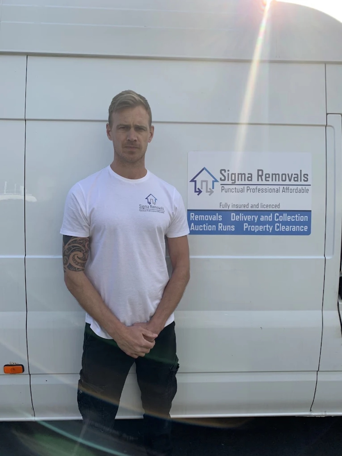 Chris, founder of Sigma Removals, standing beside the branded removal van in Devon
