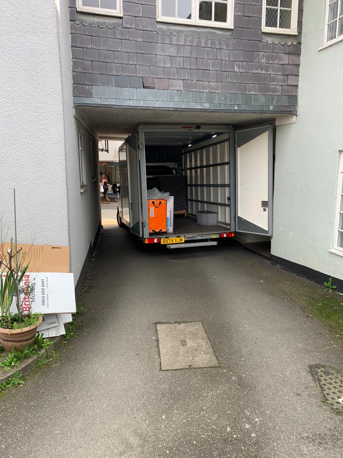 Sigma Removals van reversed into a narrow alleyway beside a period property in Devon