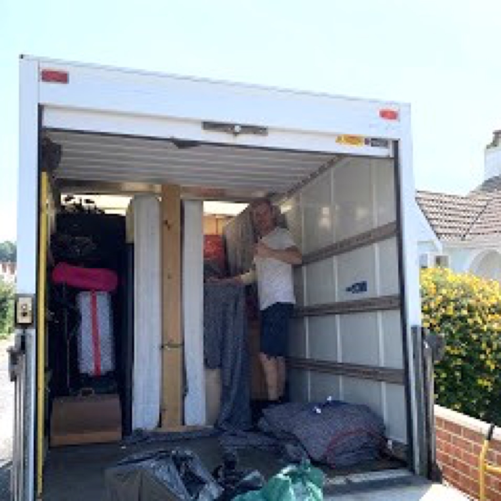 Sigma Removals team member loading furniture into the Luton van during a house move