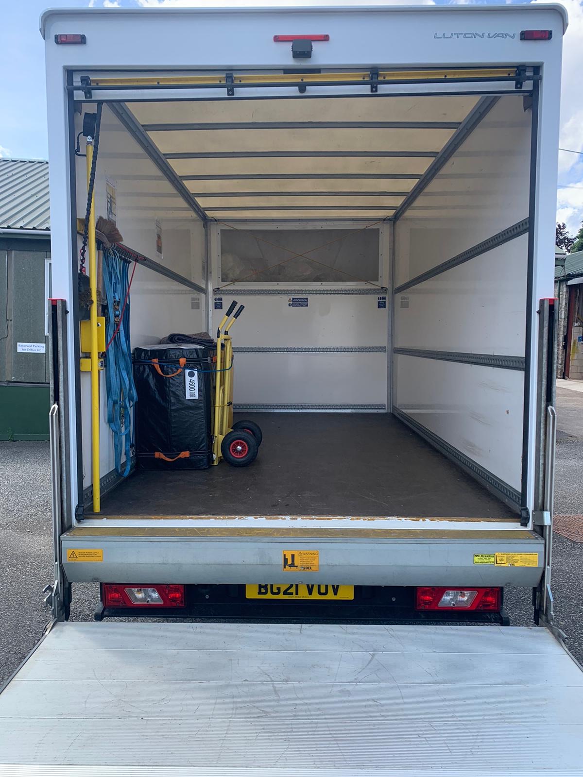 Interior of a clean Sigma Removals Luton van fitted with trolley and protective blankets