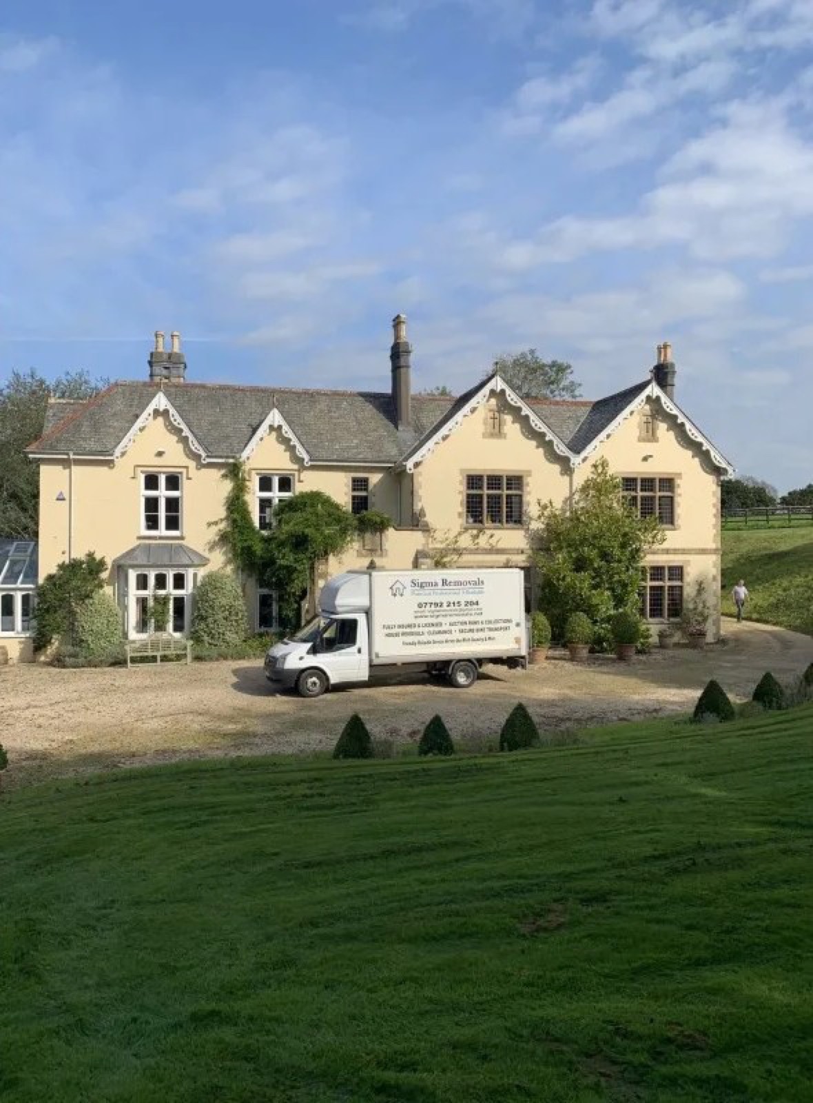 Sigma Removals van outside a large Devon country house on a sunny day